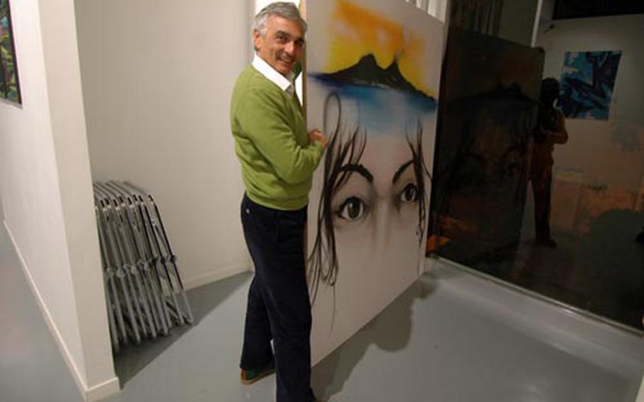 Entropy Art gallery manager Mauro Filomarino displays the work of graffiti artist Daze, on view until the end of November.