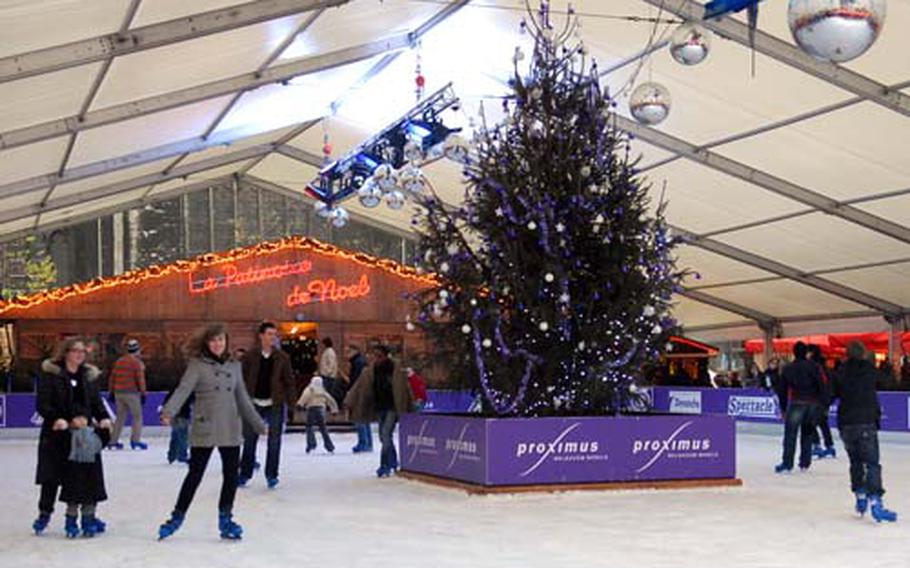 Skaters enjoy the ice rink set up on the cathedral square in Liège, Belgium.