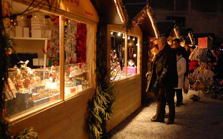 Visitors at the Christmas market in Liège, Belgium, shop for decorations and gifts.