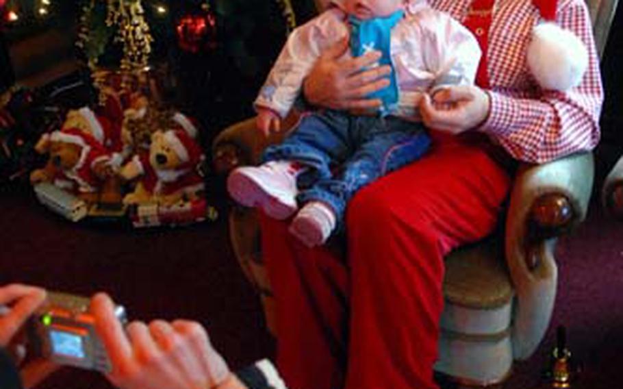 St. Nick poses with a young one at the Christmas market in Maastricht.