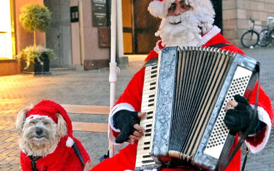 It seems Santa has made his list and checked it twice and has now taken up playing Christmas carols for passersby in downtown Nuremberg, Germany. It also appears he ditched Rudolph for a smaller four-legged friend.