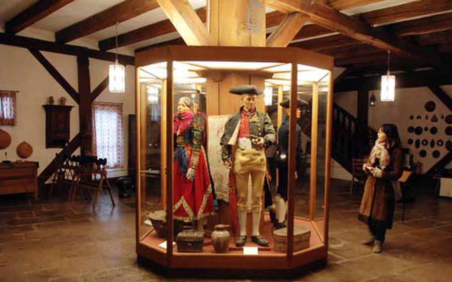 A tourist checks out a display of traditional festive costumes from the Ochsenfurt region in the folk art section of the museum.