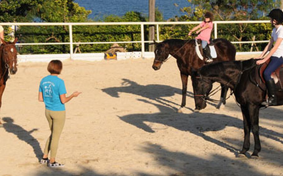 Samantha Straub gives instructions to a riding class at the club&#39;s arena. The club&#39;s instructors teach the English style of riding, which includes both hands on the reins. Western riding, which evoved partly from ranching needs, often uses only one hand on the reins, freeing the other hand for ranch work.