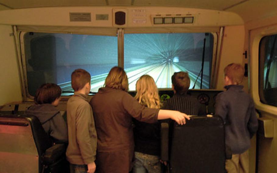 Visitors try their hand at being an engineer on a simulator at the DB Museum.