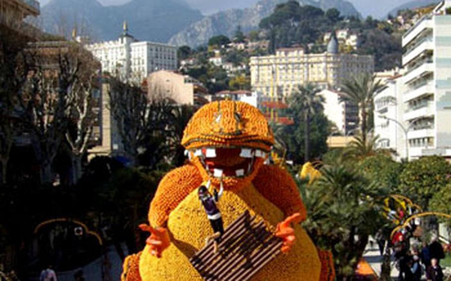 A fire-breathing dragon clutches a pirate and his raft in one of the displays created from 145 tons of lemons, oranges and other citrus fruits at the Lemon Festival in Menton.