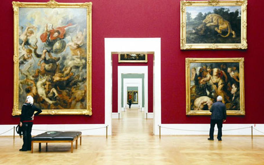 Visitors view paintings by Peter Paul Rubens at the Alte Pinakothek. The museum features paintings from the 14th to the 18th century.