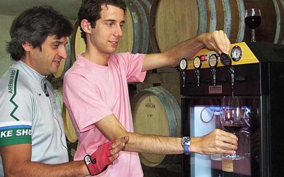 Alessio Pagliai serves red wine to Riccardo Baldan. Podere Ristrella, a family winery, produces grappa and olive oil in addition to wine.