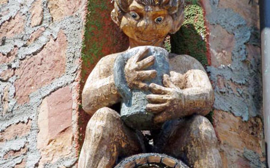 This statue of a guy looking into his beer mug adorns an old house in Weinheim, Germany.