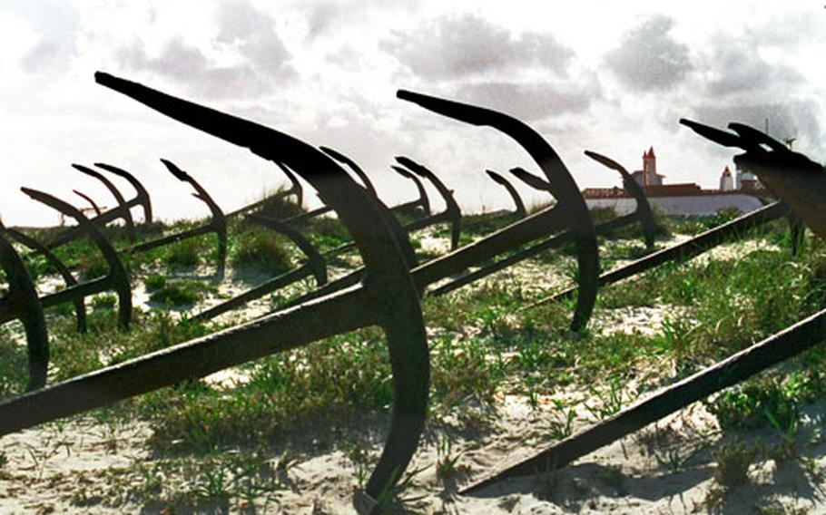 Anchors from a former sardine fleet rest on sand dunes at the Ria Formosa National Park in Portugal. The ships were used to fish off the coast near Tavira — a task once made easier with the help of Portuguese water dogs.