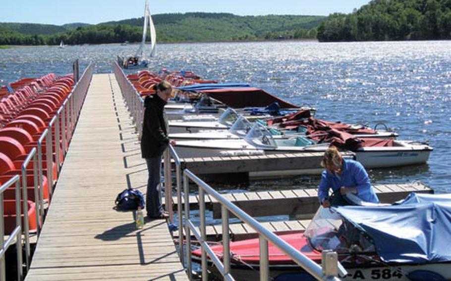 Boaters prepare their craft for a day on the Bostalsee in Bosen, Germany, not far from Baumholder and Kaiserslautern. In addition to swimming and sunbathing at the lake, one can rent a variety of boats, including the red paddleboats seen in the far left of the picture.