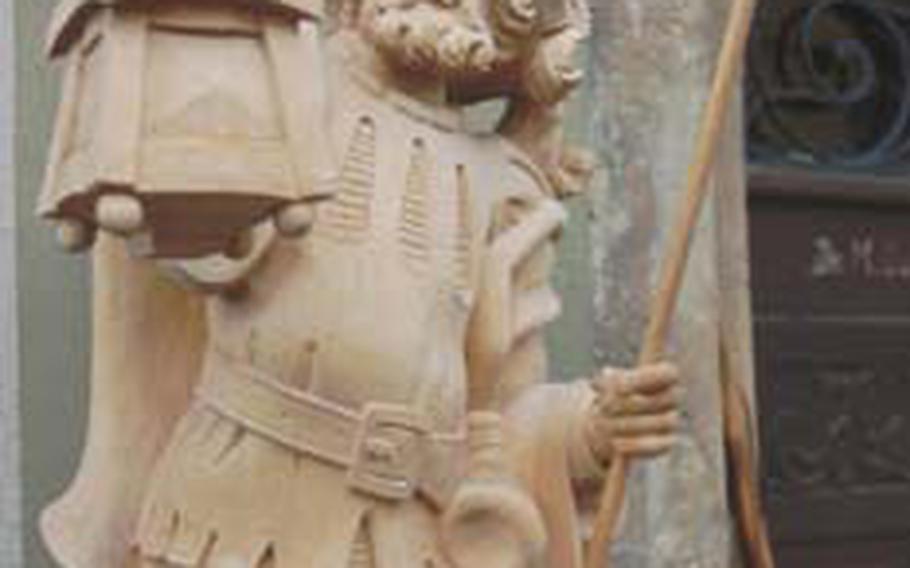 This wood carving of night watchman never goes off duty.