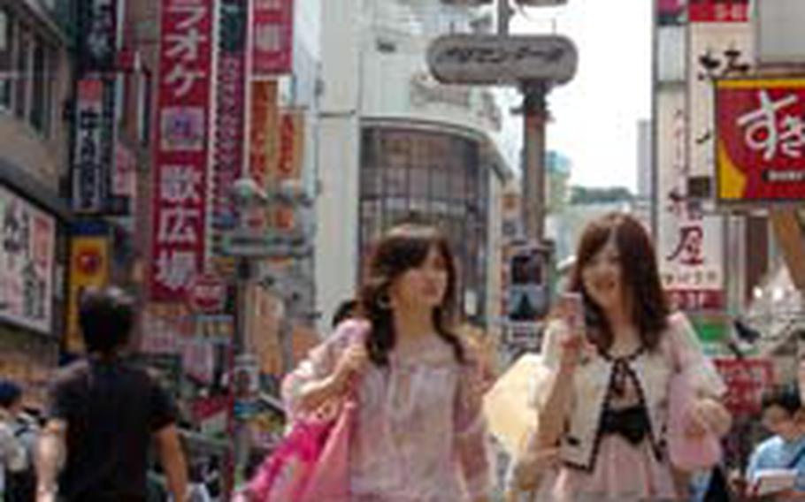 Young women dressed in latest fashions walk down Center Gai street, one of the main streets in Shibuya crowded with shops.