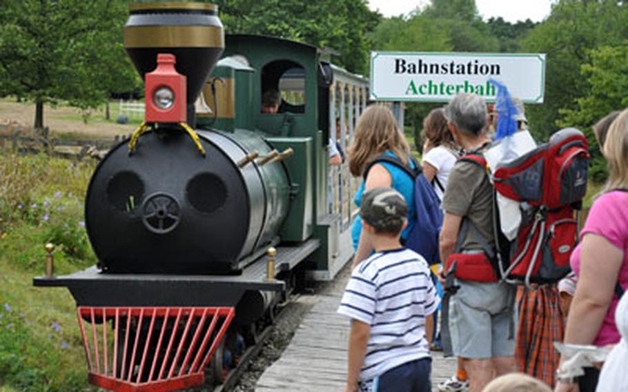 Guests await a train at one of the many train stations at the adventure park. In addition to this old-time train, the park offers an above-ground rail ride.