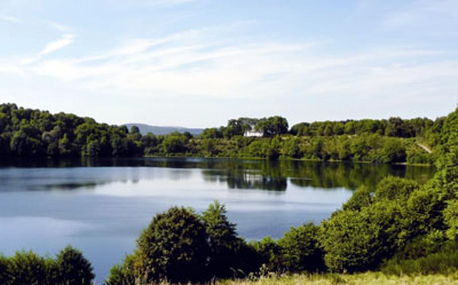 A view of the Weinfelder Maar, with the Weinfelder church in the distance. A Maar is a volcanic lake.