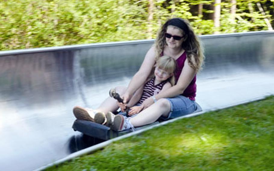 Mom and daughter roll down the summer toboggan course near Daun. Tobogganing is one of many things to do in the area.