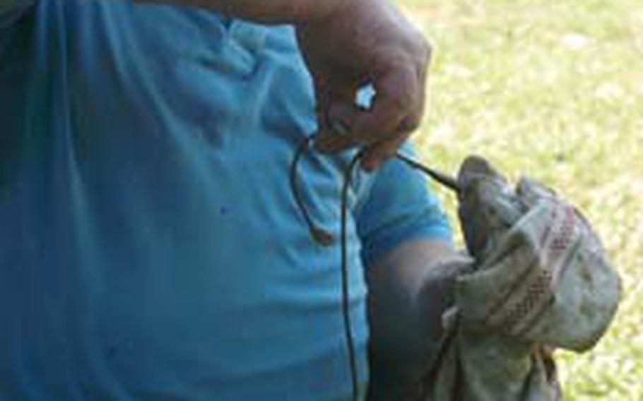 Sometimes getting the hook out of the fish’s mouth takes more time than actually catching it at a place such as Lago Orzaie. The Bertoldo family caught about two dozen fish in a bit more than an hour.