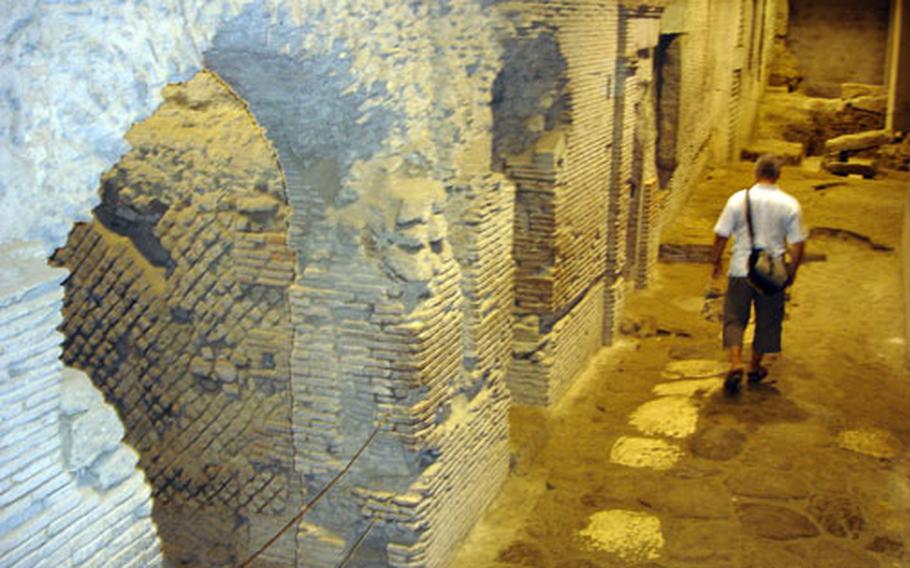 Visitors wander through the stone paths of the underground before San Lorenzo Maggiore in Naples. Archaeologists say the walls, archways and walks date back to the sixth century B.C.