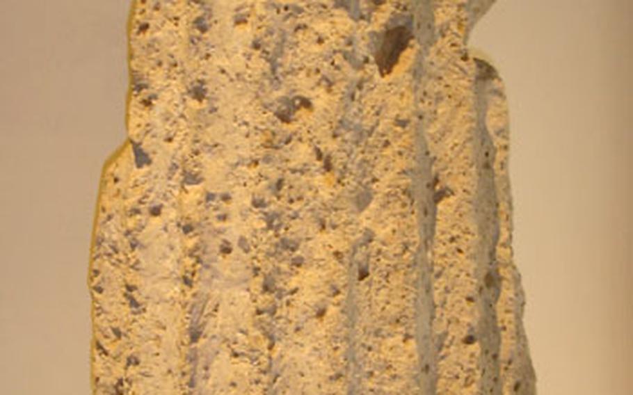 A chunk of the city&#39;s distinct yellow tufo stone, common in construction in Roman times, is on display in the museum.