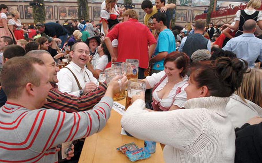 Celebrants toast one another in the Hofbrauhaus-Festhalle at last year’s Oktoberfest in Munich. This year the festivities run from Sept. 19 to Oct. 4.