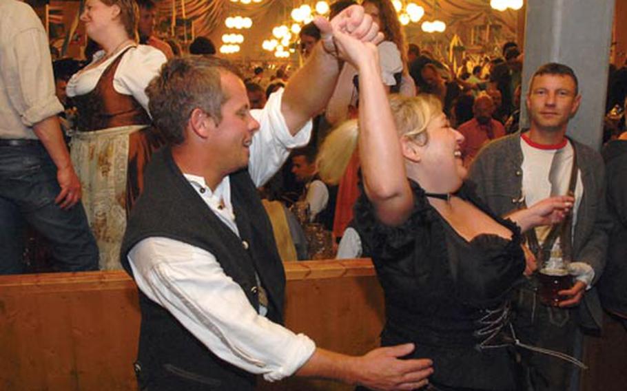 A couple enjoys a dance in a beer tent at last year’s fest.