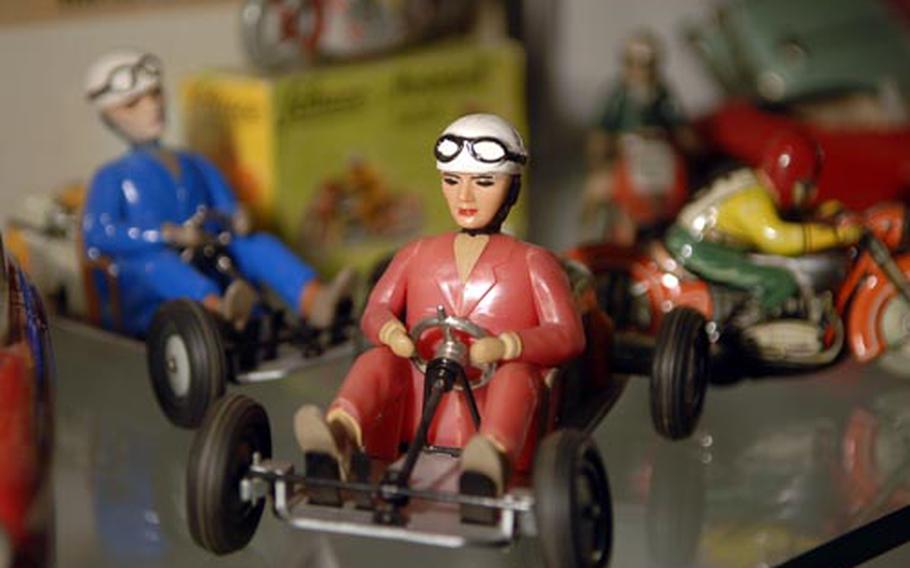 Many toys with wheels, such as these race cars, can be seen at the toy museum.