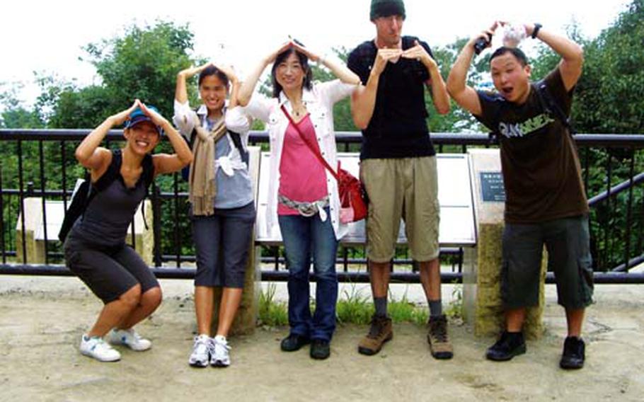 The reporter and his friends pause to pose near the top of Mount Takao during their trek up to its popular Beer Mount restaurant.