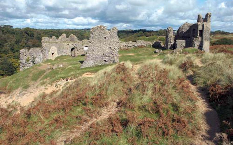 Some 12th-century ruins of Pennard Castle beside the Pennard Golf Club.