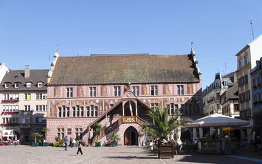 The town hall for Mulhouse, France, was built in 1552 and is unusual for France. Its exterior is painted to give the impression of pillars, balcony railings and statues. It sits on one end of the Place de la Reunion in the pedestrian zone.