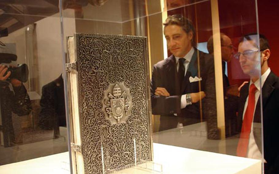 A book made of hand-carved silver contains Pope Benedict XVI’s first encyclical — hand-printed and illustrated with vegetable dyes and gold leaf. The piece is part of the exhibit honoring Caterina de’ Medici at Complesso del Vittoriano in Rome.