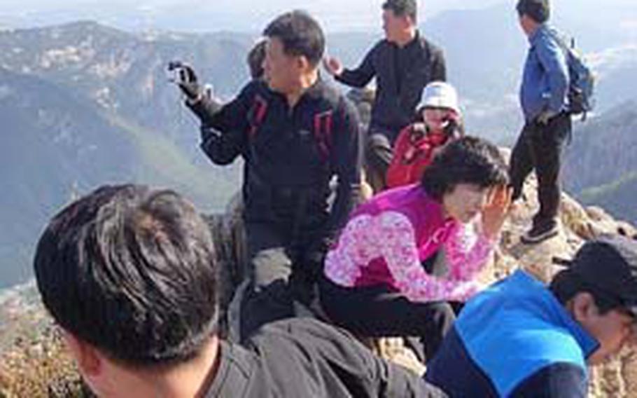 Hikers enjoy the view at the peak of Seoraksan&#39;s Gwongeumseong mountain.