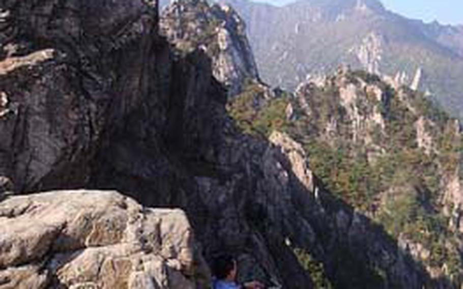 A man sits on the edge of Gwongeumseong mountain, a popular stop within Seoraksan National Park.