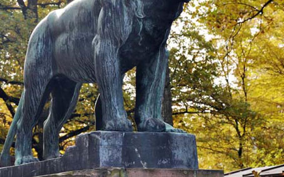 A statue of a man and a lion stands at the entrance to the zoo, founded in 1912.