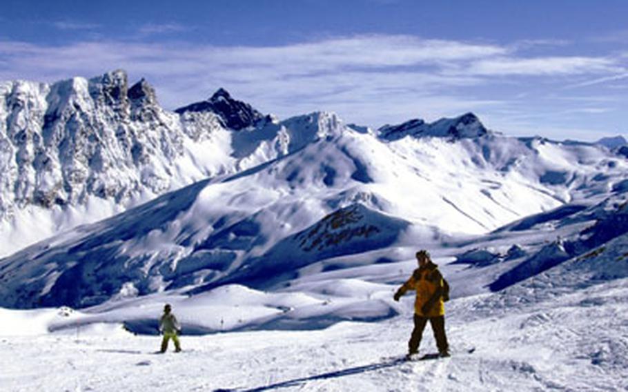 Snowboarders practice on a deserted slope at the Savognin ski resort in Switzerland, near Radons.