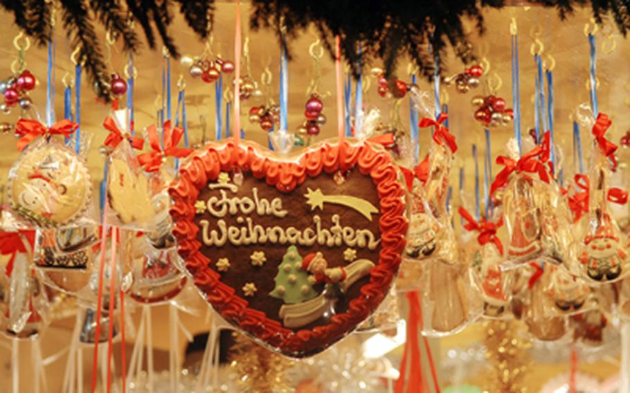 A gingerbread heart hanging in a stall at the Nuremberg, Germany, Christkindlesmarkt wishes passers-by a merry Christmas.
