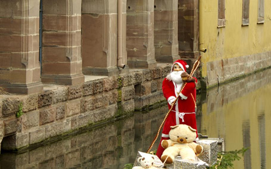 To prevent his reindeer’s feet from getting wet, this toy stuffed Santa uses a small boat to float over the canals of "Petite Venise" to visit the children’s part of the Christmas market in Colmar, France.