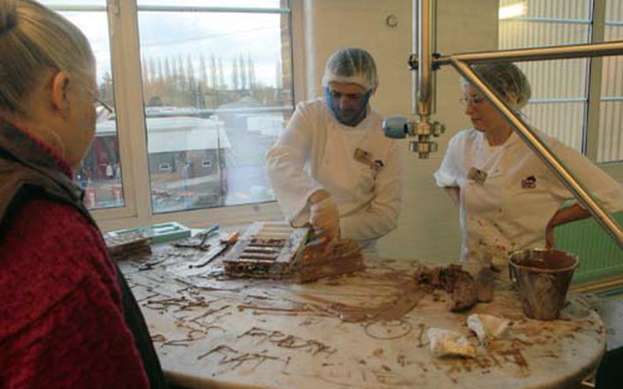 Chocolatiers at Cadbury World demonstrate traditional methods of chocolate making during a tour at the factory.