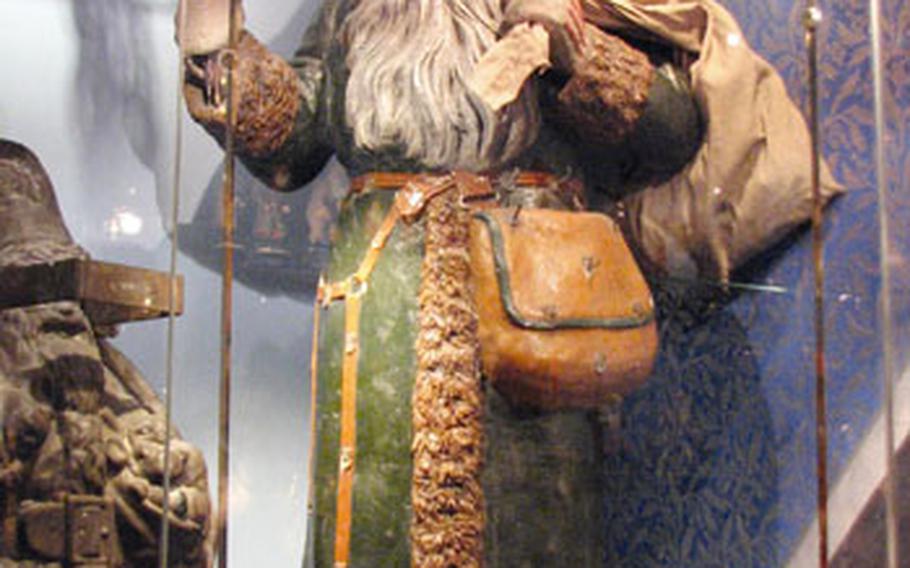 A large carving of St. Nicholas holds switches in his right hand as a stern reminder that he knows who has been naughty and nice.