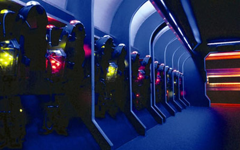 A row of laser tag vests glows in the holding chamber.