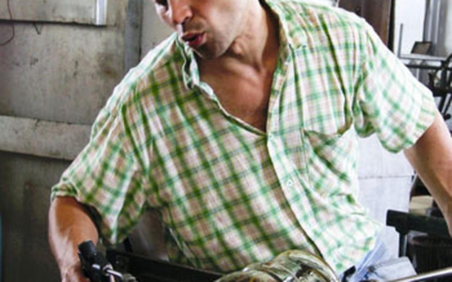 An Eisch employee shapes up one of the company’s creations in its workshop in the Bavarian Forest.