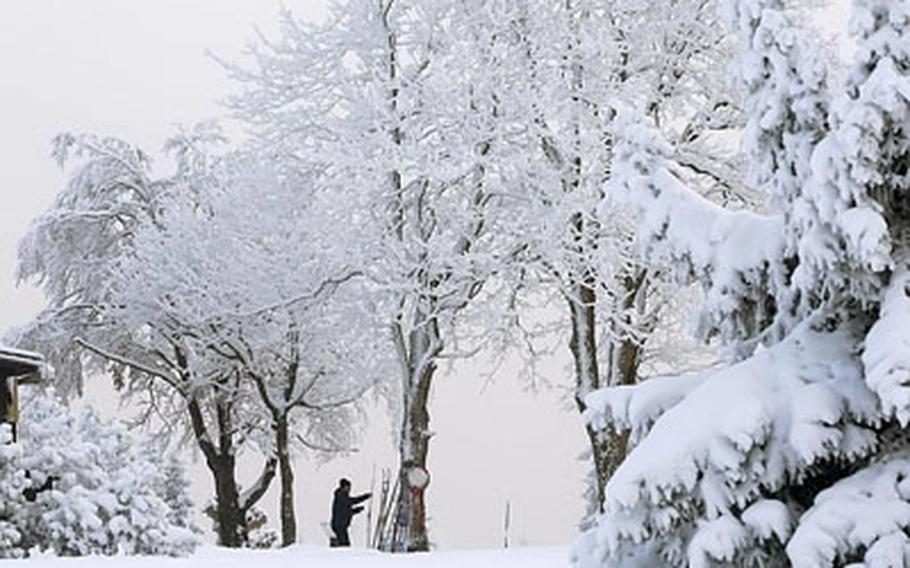 A man prepares his skis while enjoying a fresh snowfall near the village of Korenov, about 60 miles north of Prague, Czech Republic.