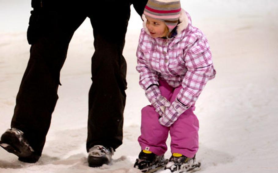 A young skier gets a helping hand and a gentle push from dad at Snow Valley.