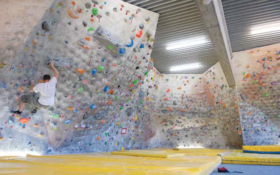 A climber makes his way around a bouldering room at the Extreme Climbing Center in Ludwigshafen. The room covers 3,000 square feet of fake caves and cliffs that climbers can tackle without ropes