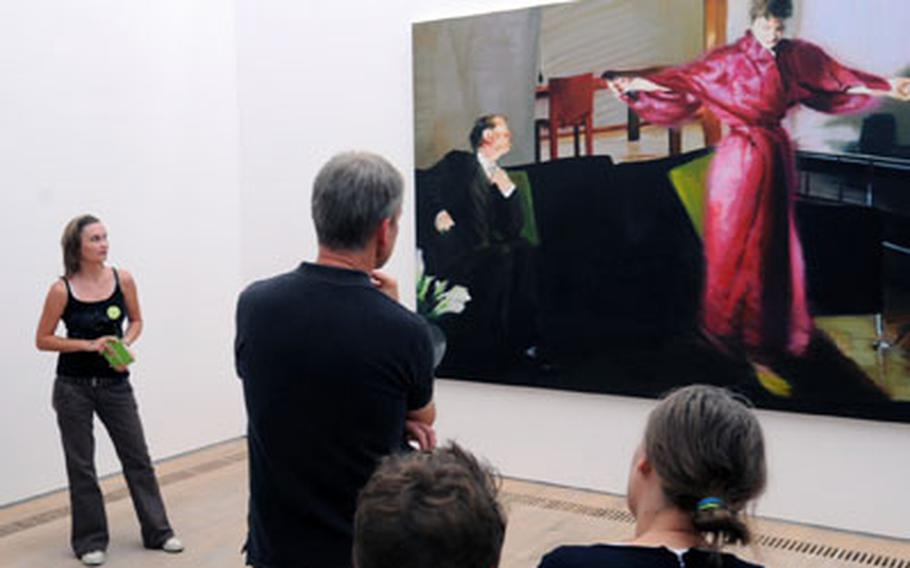 A guide talks about Eric Fischl’s masterpiece “Living room no. 3,” one of the many highlights of the museum.