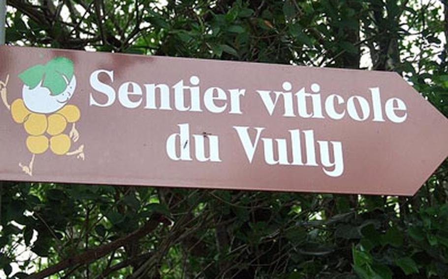 A sign shows the way to the wine trail through the Vully vineyards.