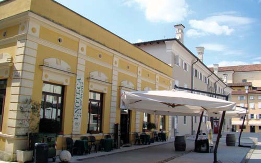 The Enoteca of Cormons is in the center of the village of Cormons. Barrels set up underneath large umbrellas outside the regional wine shop double as tables where you can enjoy a glass of wine purchased inside. The enoteca sells and promotes wine from 33 local winemakers.