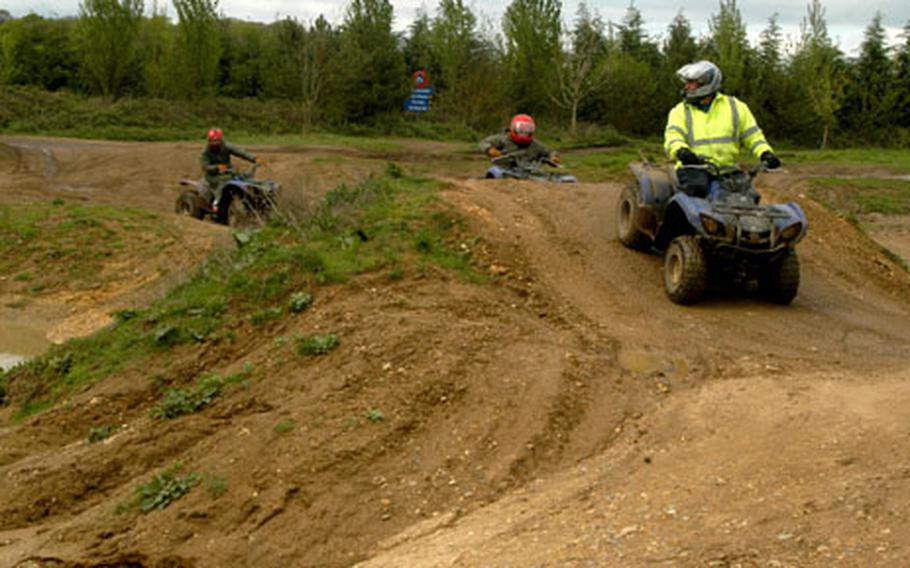 An instructor at the WildTracks outdoor center leads a group of youngsters around the 4-by-4, off-road track on all-terrain vehicles.