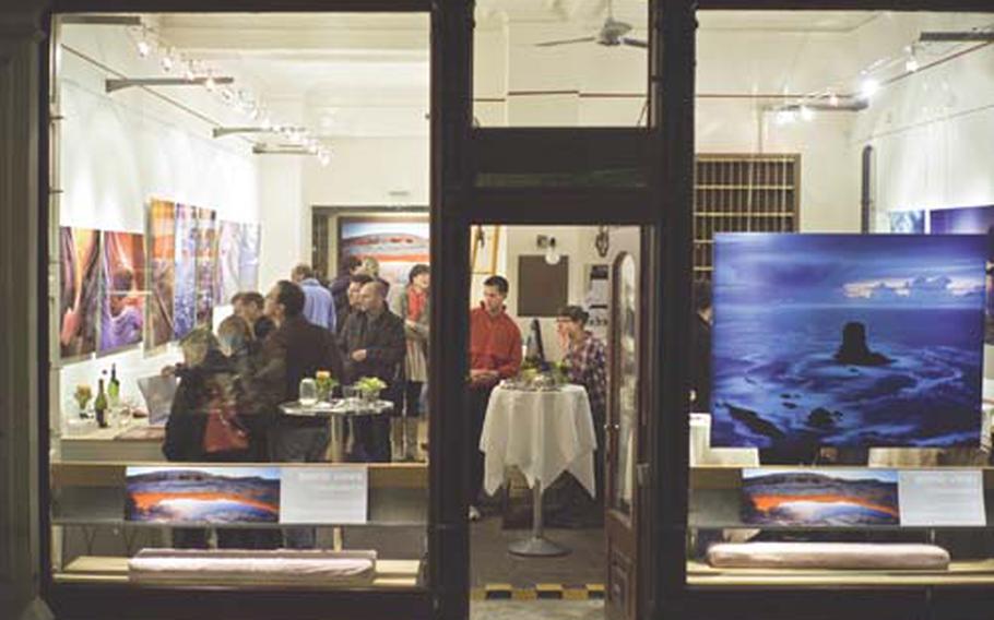 Alexander Ehhalt’s gallery is filled with his large color photographs of nature and a crowd of viewers during Heidelberg’s Long Night of Museums.