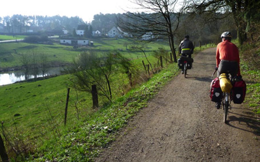 This stretch of the  Glan-Blies-Weg is wide and flat and goes through beautiful scenery. Luke Stover, right, and Nick Schulte ride in the early morning near Schönenberg-Kübelberg in Germany on an overnight trip in the spring retracing part of the bike trip to France.