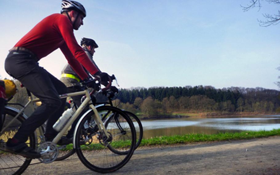 Luke Stover, left, and Nick Schulte ride along the reservoir near Schönenberg-Kübelberg on the return leg of an overnight bike-camping trip in the spring that retraced part of a two-day round trip to France in the summer.