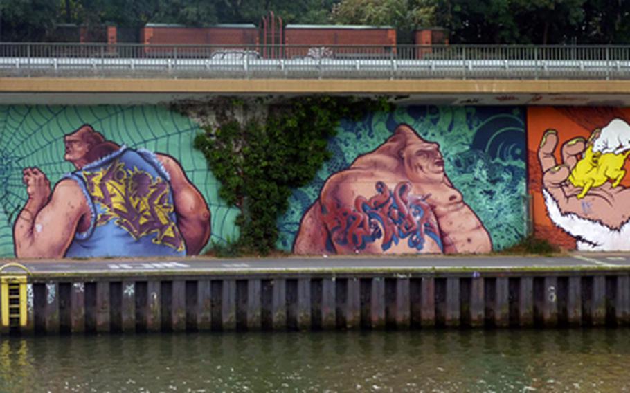 Detailed graffiti murals along the Saar River in Saarbrücken, Germany, make for interesting viewing on the way to France.